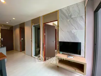 Modern apartment interior with sleek design and built-in TV unit