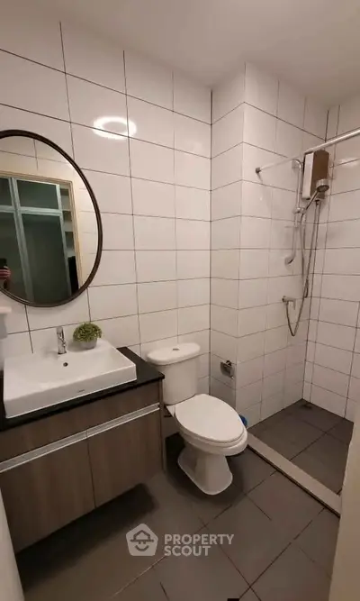 Modern bathroom with sleek fixtures and a spacious shower area in a contemporary apartment.