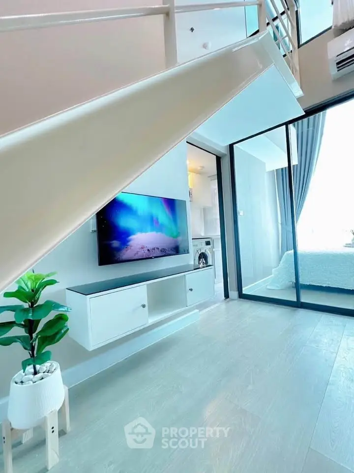 Modern duplex apartment with sleek interior design and stylish decor, featuring a cozy living area and bedroom.