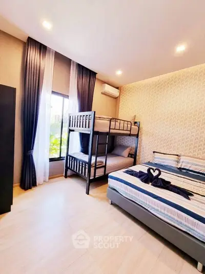 Modern bedroom with bunk bed and stylish decor, perfect for family living.