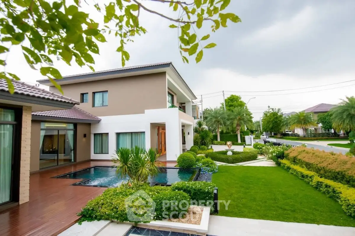 Luxurious modern home with lush garden and private pool in serene neighborhood.