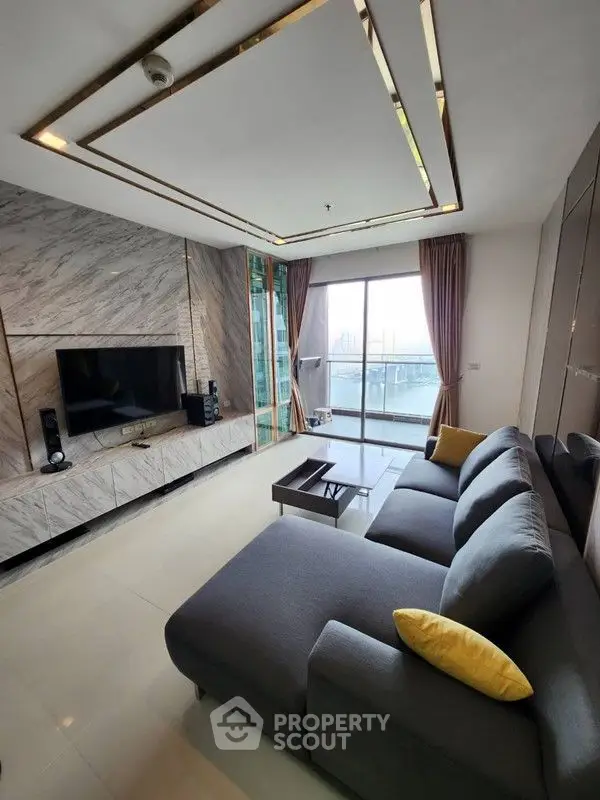 Luxurious living room with modern decor and stunning city view from balcony.