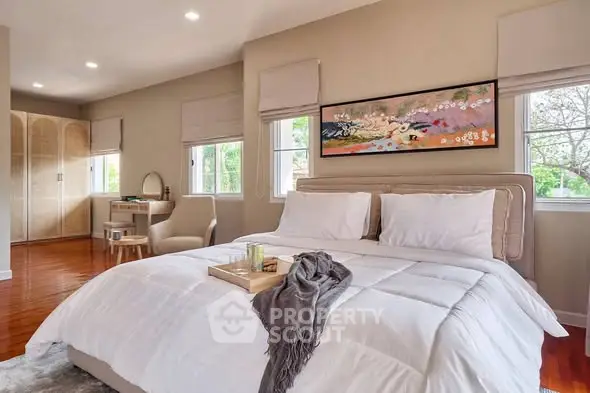 Luxurious bedroom with elegant decor and natural light, featuring a cozy bed and stylish furnishings.