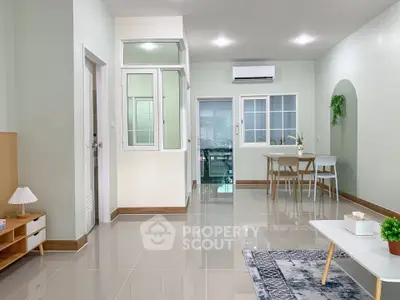 Spacious modern living room with dining area and sleek tile flooring