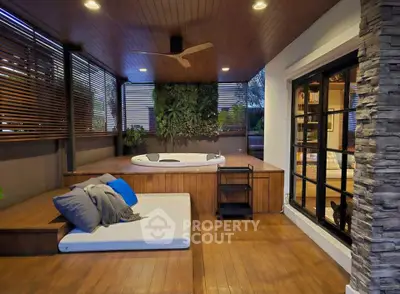Luxurious outdoor terrace with jacuzzi and stylish seating area, perfect for relaxation and entertainment.