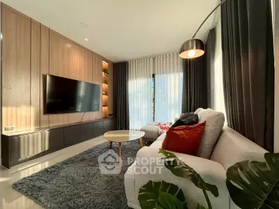 Modern living room with sleek design, cozy sofa, and large TV, perfect for relaxation.