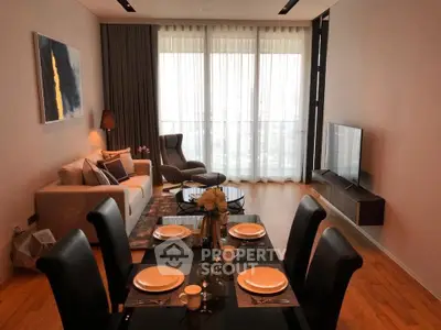Modern living room with elegant dining area and large windows offering natural light.