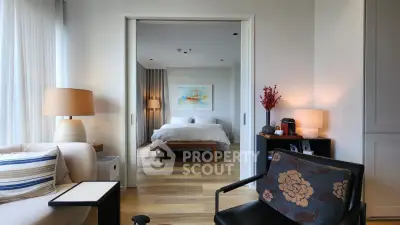 Stylish modern bedroom with cozy seating area and elegant decor