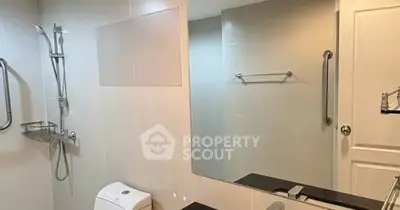 Modern bathroom with sleek fixtures and large mirror