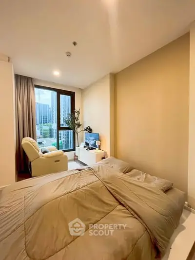 Cozy bedroom with modern decor and large window offering city view