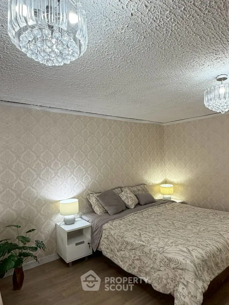 Cozy bedroom with elegant lighting and stylish decor, perfect for relaxation and comfort.