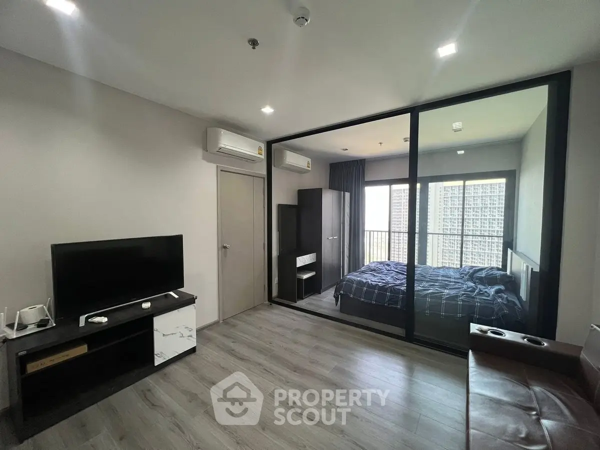 Modern apartment with glass partitioned bedroom and sleek living area