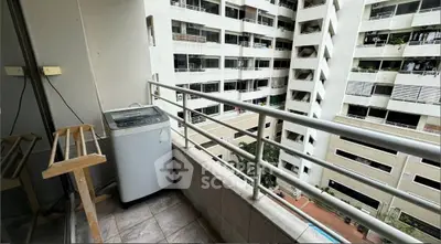 Spacious balcony with washing machine overlooking modern apartment complex