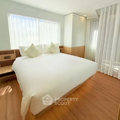 Bright and spacious bedroom with large windows and modern decor