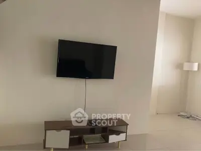 Modern living room with wall-mounted TV and sleek console table, perfect for minimalist design enthusiasts.