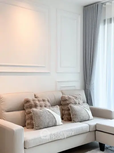 Elegant living room with plush sofa and stylish decor in modern apartment.