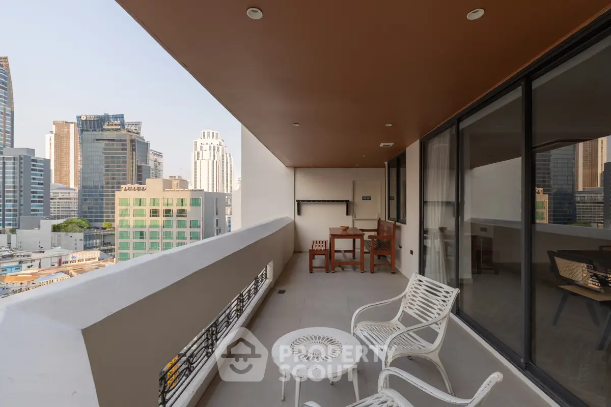 Spacious balcony with city view, perfect for relaxation and entertainment in urban setting.