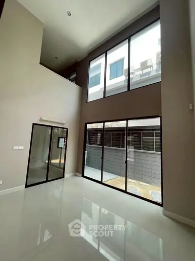 Spacious modern living room with high ceilings and large windows