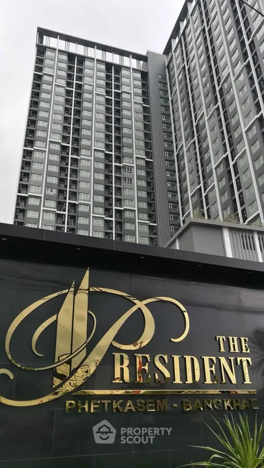 Modern high-rise condominium building with elegant signage in Bangkok.