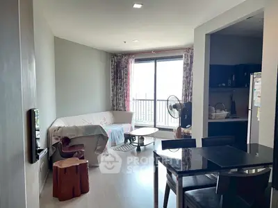 Cozy living room with natural light and modern furnishings in a stylish apartment.