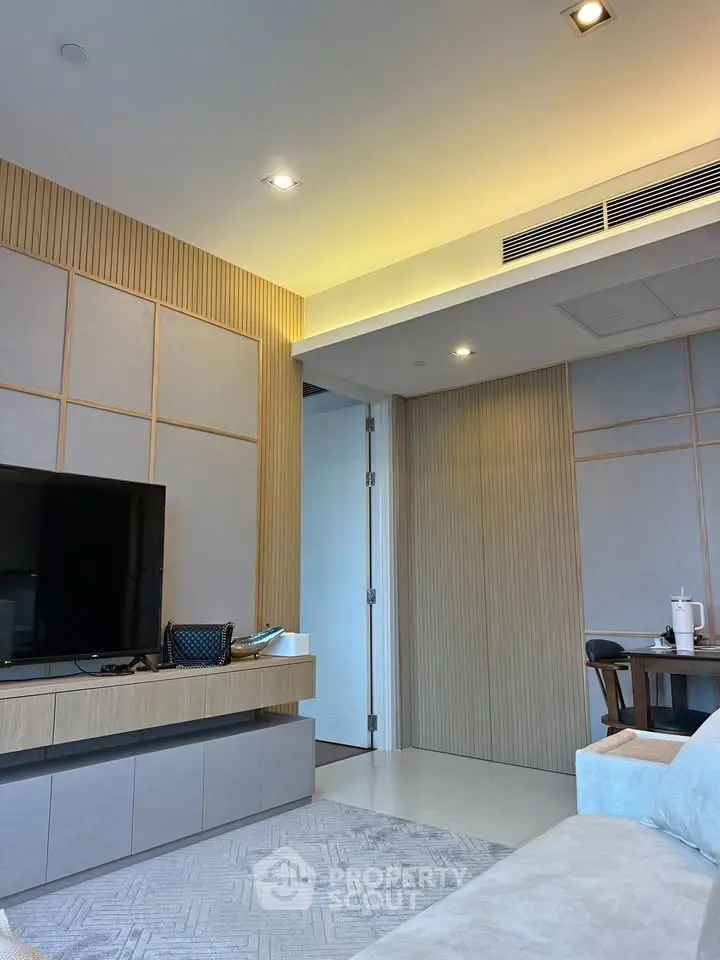 Modern living room with sleek TV unit and cozy seating area