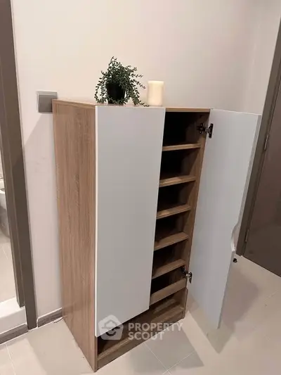 Modern wooden storage cabinet with open shelves in a stylish interior setting.