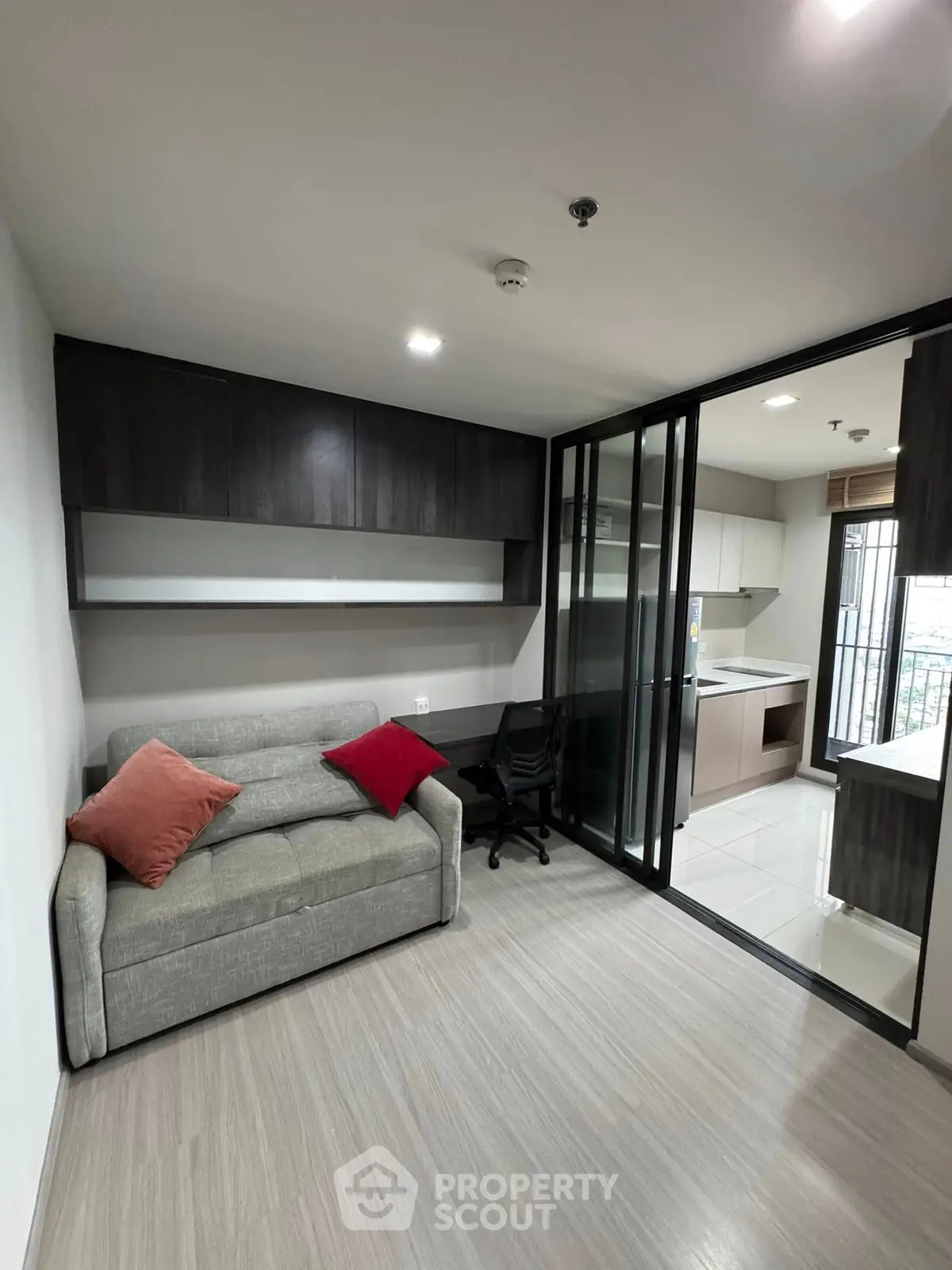 Modern living room with sleek design and open kitchen layout in a stylish apartment.