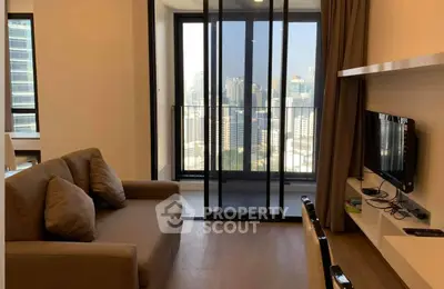 Modern living room with city view and cozy sofa in high-rise apartment.