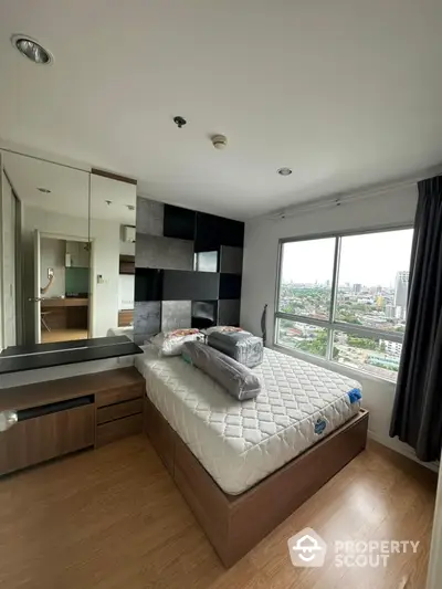 Modern bedroom with city view, featuring stylish decor and ample natural light.