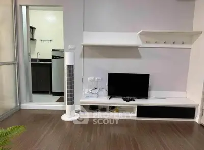 Modern living room with sleek TV setup and open kitchen view