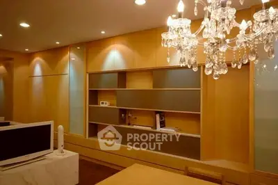 Elegant living room with chandelier and modern built-in shelving