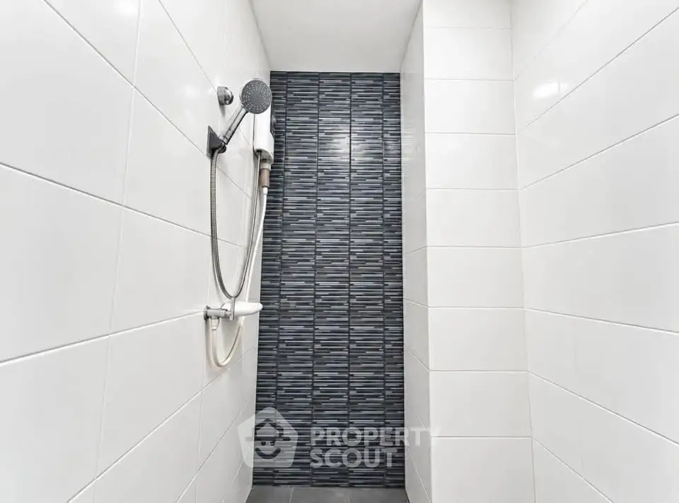Modern bathroom shower with sleek tile design and contemporary fixtures.