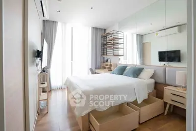 Modern bedroom with stylish decor, large windows, and ample storage space in a contemporary apartment.