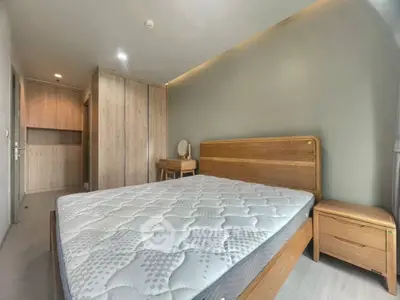 Spacious bedroom with wooden furniture and cozy ambiance