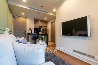 Modern living room with sleek TV and cozy seating in stylish apartment