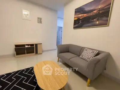 Modern living room with stylish sofa and wooden table, perfect for relaxation.