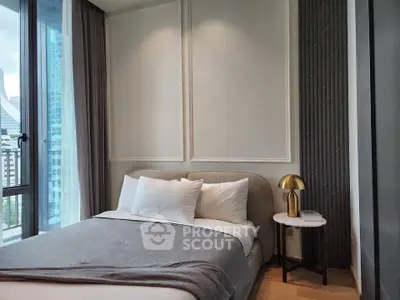 Modern bedroom with elegant decor and large windows offering city views.