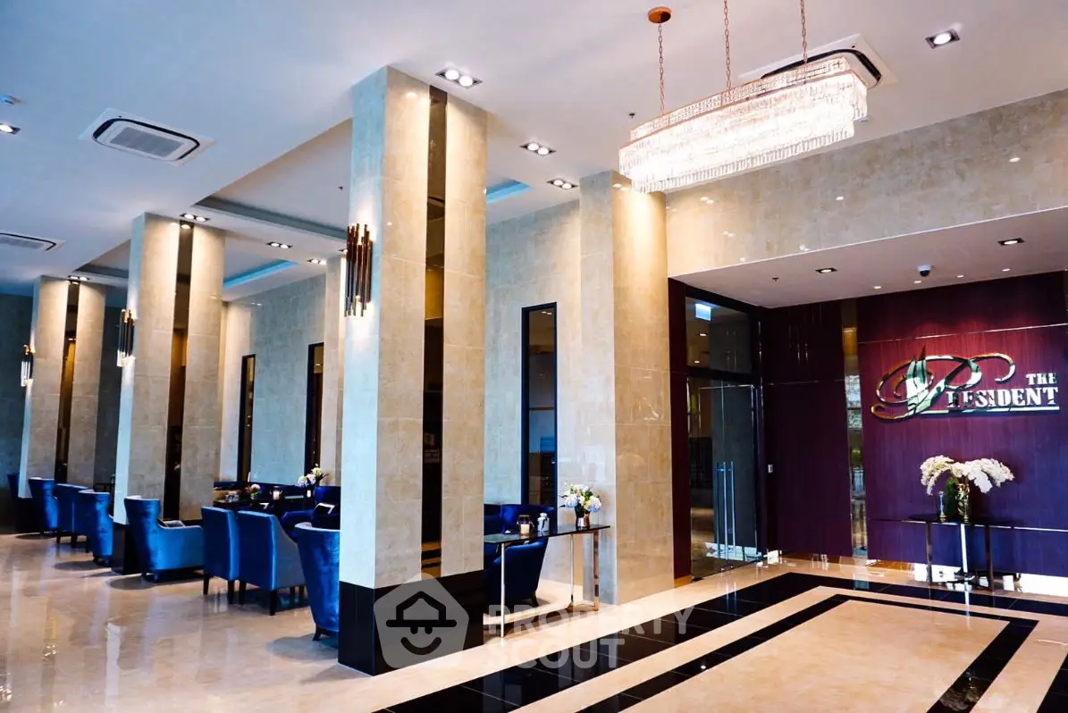 Luxurious lobby with elegant seating and chandelier in upscale building