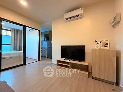 Modern living room with sleek design and open layout, featuring air conditioning and stylish furniture.