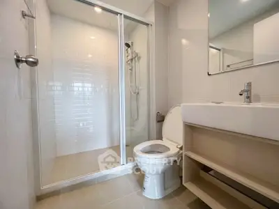 Modern bathroom with glass shower and sleek fixtures