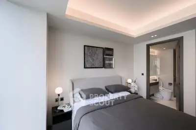 Modern bedroom with ensuite bathroom, featuring sleek design and ambient lighting.