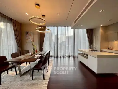 Luxurious dining and kitchen area with elegant lighting and city view