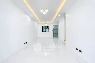 Spacious modern living room with elegant lighting and glossy white flooring
