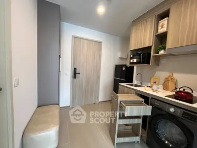 Modern compact kitchen with built-in appliances and stylish cabinetry in a cozy apartment.