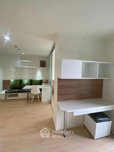 Modern study area with sleek white desk and shelving, perfect for productivity.