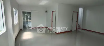 Spacious empty living room with large windows and glossy floor tiles