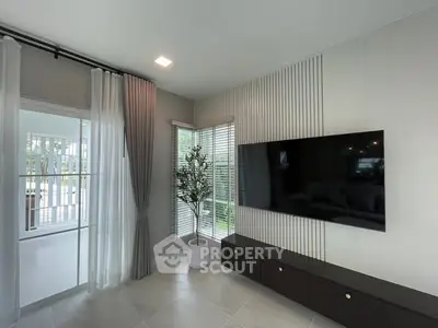 Modern living room with large TV and stylish decor
