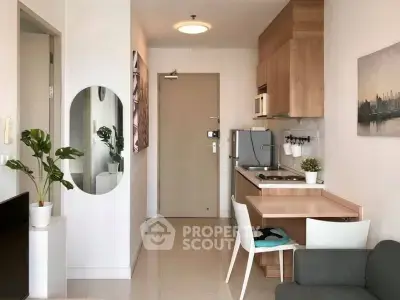 Modern compact kitchen with wooden cabinets and cozy dining area in a stylish apartment.