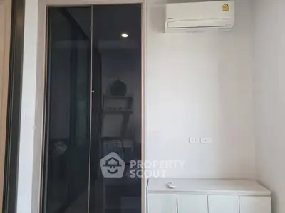 Modern bedroom with sleek wardrobe and air conditioning unit