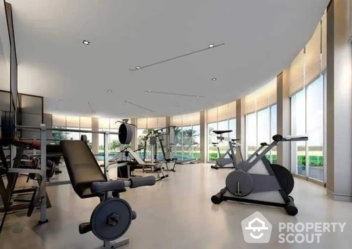 Spacious modern gym with state-of-the-art equipment and panoramic windows